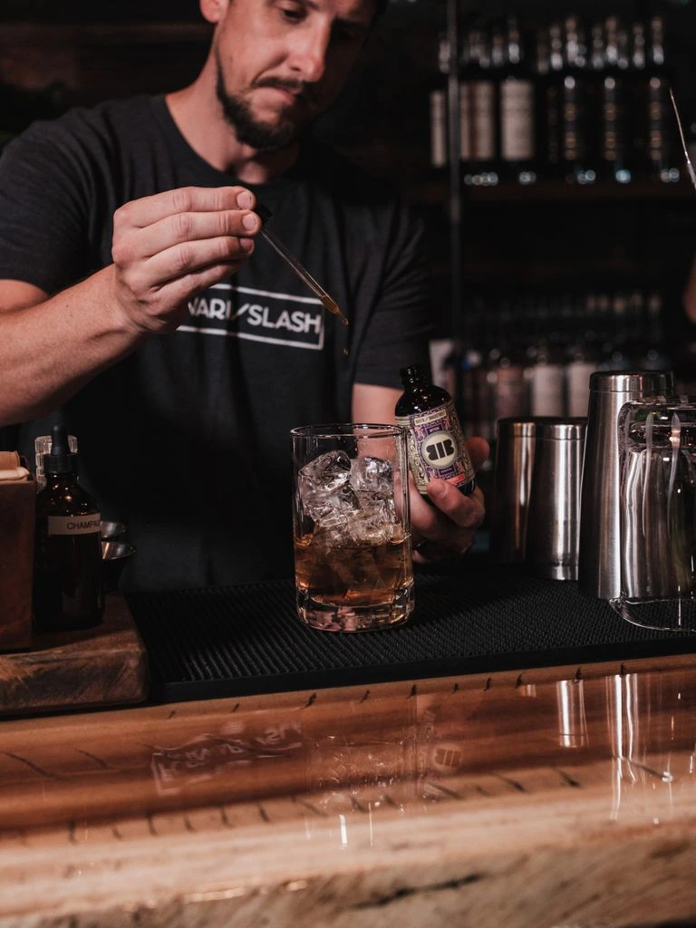 Bartender pouring a craft beer from the forty-tap wall at DNA Rock Cafe