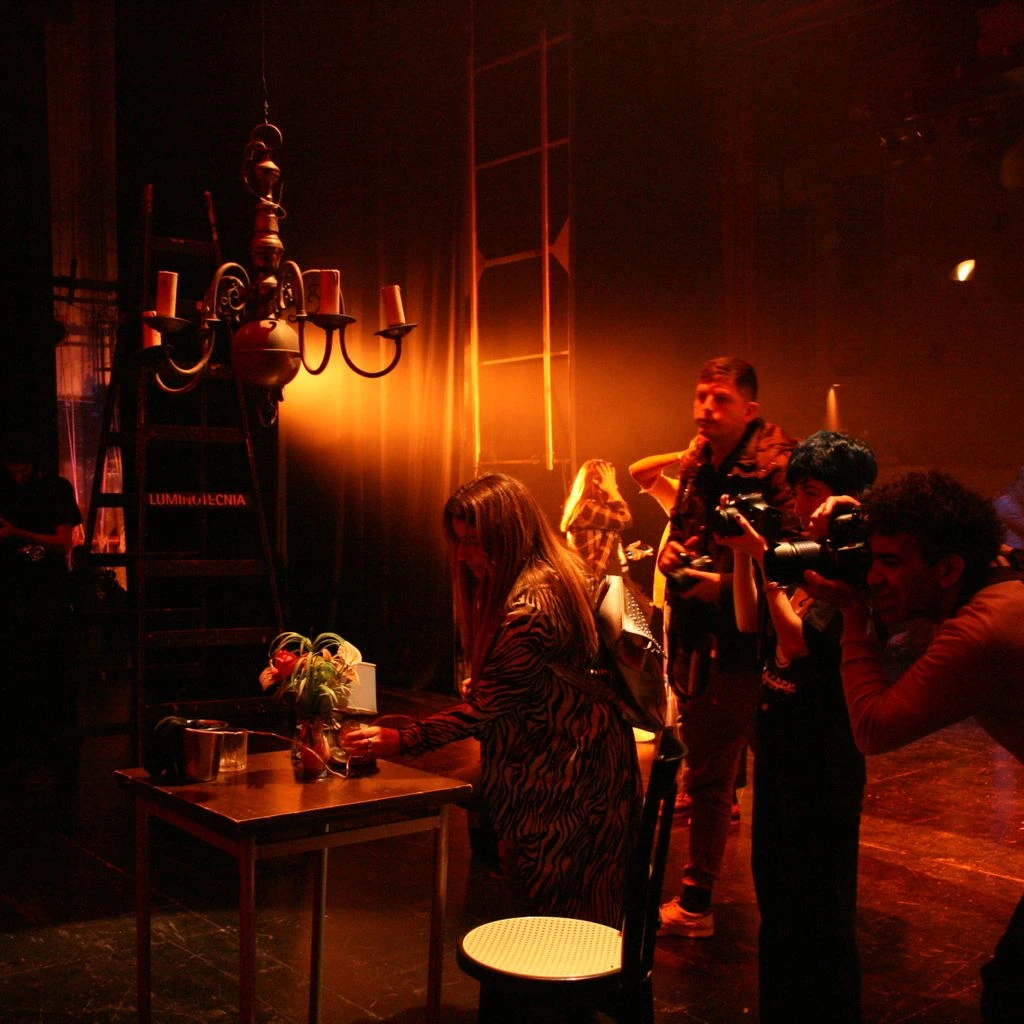 Stage-front rail with reserved high-tops inches from the performance stage
